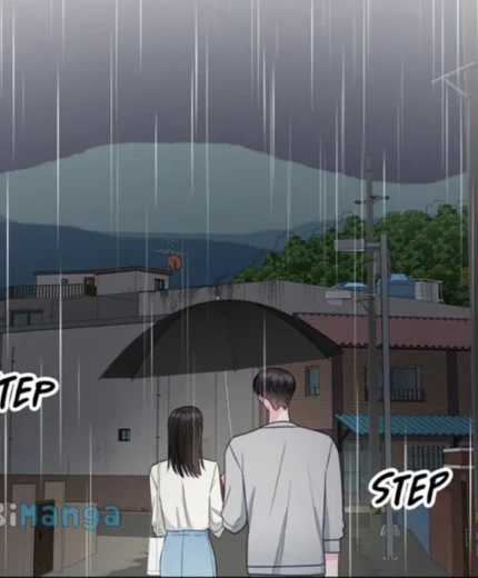 Couple waling in the rain sharing an umbrella